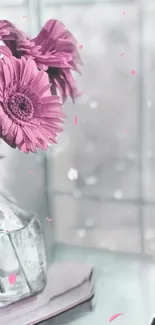 Pink flowers in a glass vase by a window, creating a soft and elegant look.