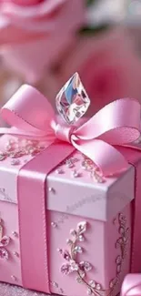 Pink gift box with floral design and gemstone.
