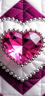 Pink heart-shaped gem with silver beads on quilted background.