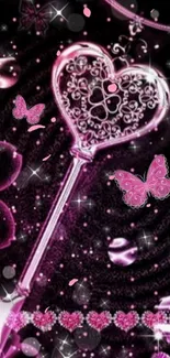 A pink heart-shaped key with butterflies and sparkles on a black background.