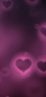 Glowing pink hearts on a purple background wallpaper.