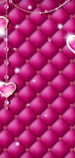 Pink quilted wallpaper with hearts and jewels.