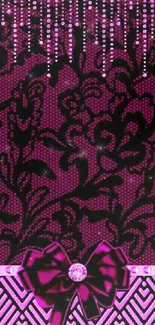 Pink and black lace pattern wallpaper with glamorous bow accent.