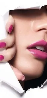 Close-up of feminine pink lips with elegant pink nails.