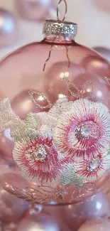 Elegant pink ornament with floral design.