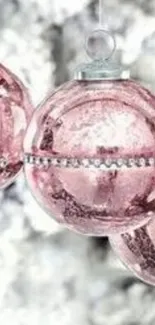 Pink Christmas ornaments with silver accents.