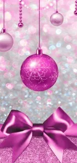 Pink ornament wallpaper with baubles and a silk bow on a glittery background.