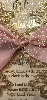 Pink ribbon tied on elegant gold lace invitation card.