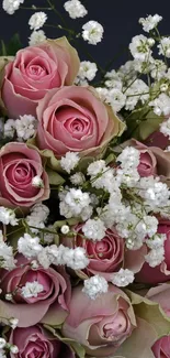 Elegant bouquet of pink roses with delicate white flowers.