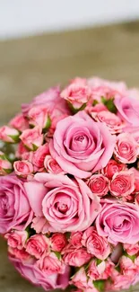 A beautiful bouquet of pink roses on a wooden background.