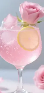 A pink cocktail with a rose garnish and lemon slice in a glass.