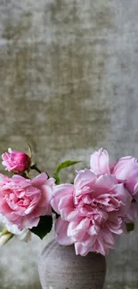 Vase with pink roses against olive green texture.