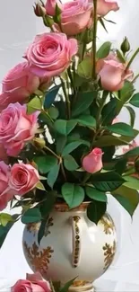 Elegant vase of pink roses with green leaves.