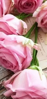 Pink roses on a wooden table, romantic wallpaper backdrop.