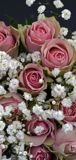 Pink roses surrounded by white baby's breath flowers, creating a floral display.