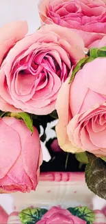 Close-up of a pink rose bouquet in a vase with a soft background.