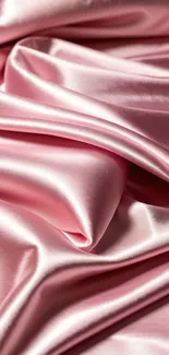 Luxurious pink silk fabric with elegant folds.