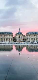 Elegant sunset with pink hues reflecting on historic building.