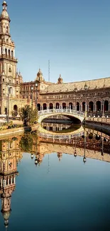 Plaza de España reflecting in still water, under a clear blue sky.
