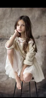 Elegant portrait of a young girl in beige on a textured background wallpaper.