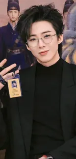 Stylish person with glasses in black outfit.