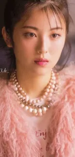 Elegant woman in soft pink tones with pearls and a warm attire.