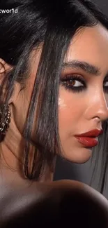 Elegant woman portrait with dark hair and striking makeup.