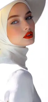 Portrait of a woman in a white hijab and hat with red lipstick.