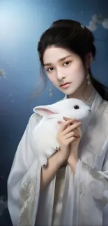 A woman in traditional attire holding a rabbit in a serene, artistic portrait.