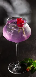 Elegant purple cocktail with red rose in glass.