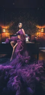 Model in a luxurious purple dress in a stylish, dimly lit room.