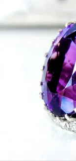 Close-up of a dazzling purple gemstone ring on white background.