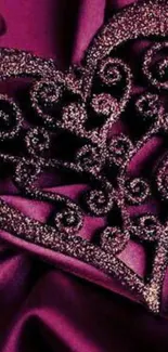 Elegant purple heart with glitter on luxurious fabric background.