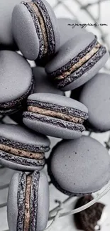 Elegant purple macarons piled artistically as wallpaper.