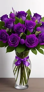 Elegant purple roses arranged in a glass vase.