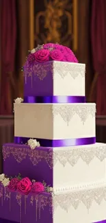 Four-tier wedding cake with purple ribbons and pink roses in elegant setting.