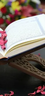 Open Quran on stand with colorful background and petals.