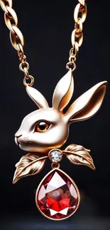 A luxurious gold rabbit pendant with a red gemstone.