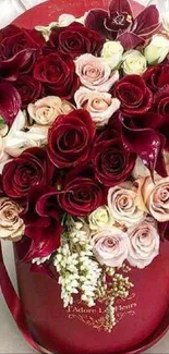 A luxurious bouquet of red and pink roses in a decorative arrangement.