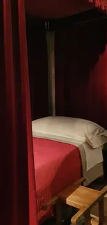 Luxurious red canopy bed with velvet curtains.