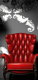 Stylish red armchair with elegant wallpaper.