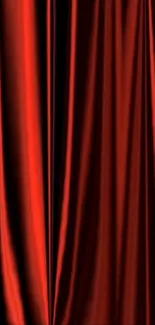 Luxurious red velvet curtain drapes in elegant waves.