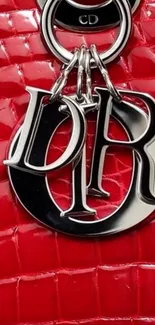 Red designer leather with metallic charm.