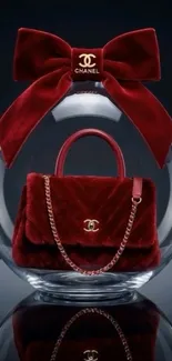 Red designer handbag with bow in glass sphere.