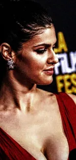 Woman in elegant red dress at a film festival.