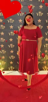 Woman in red dress with hearts and VIP backdrop.