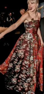 Elegant red floral gown on elegant individual at an event.