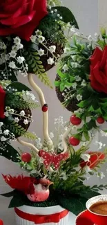 Elegant arrangement of red roses with coffee on a decorative wallpaper.