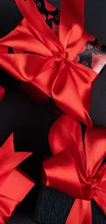 Elegant red ribbon gift boxes on a dark background.