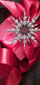 Red gift box with silver snowflake ribbon.